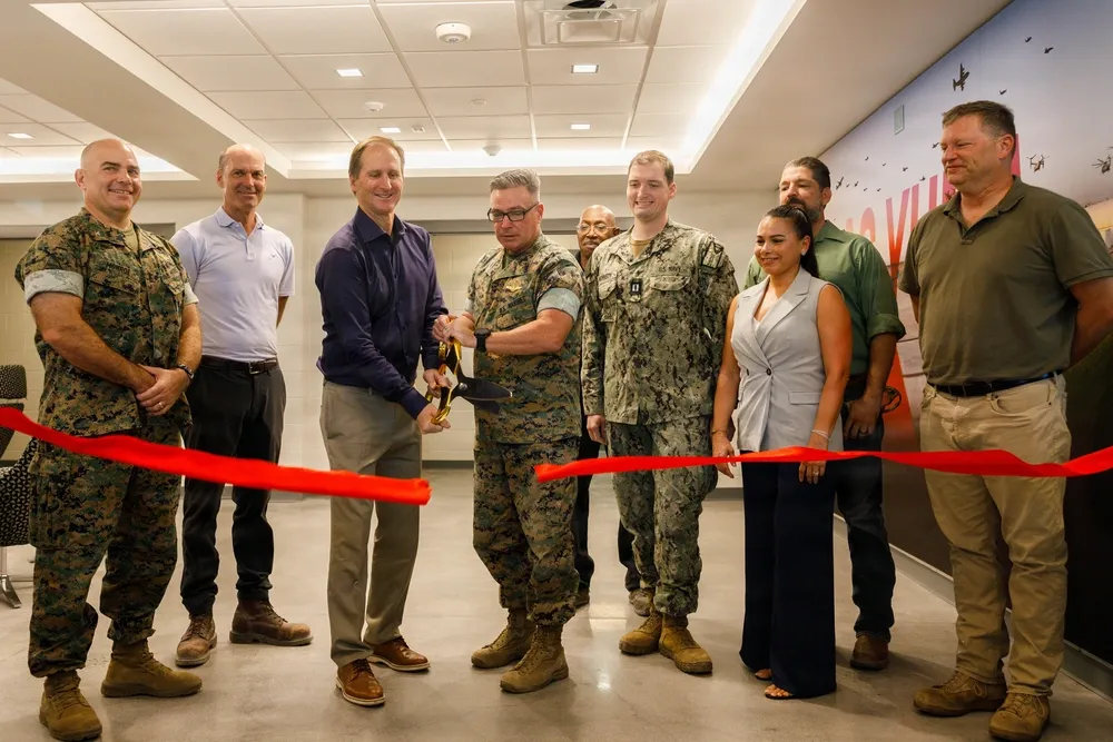 Marines and Harper Construction representatives cut a red ribbon inside the new MCAS Yuma barracks on September 25, 2026.
